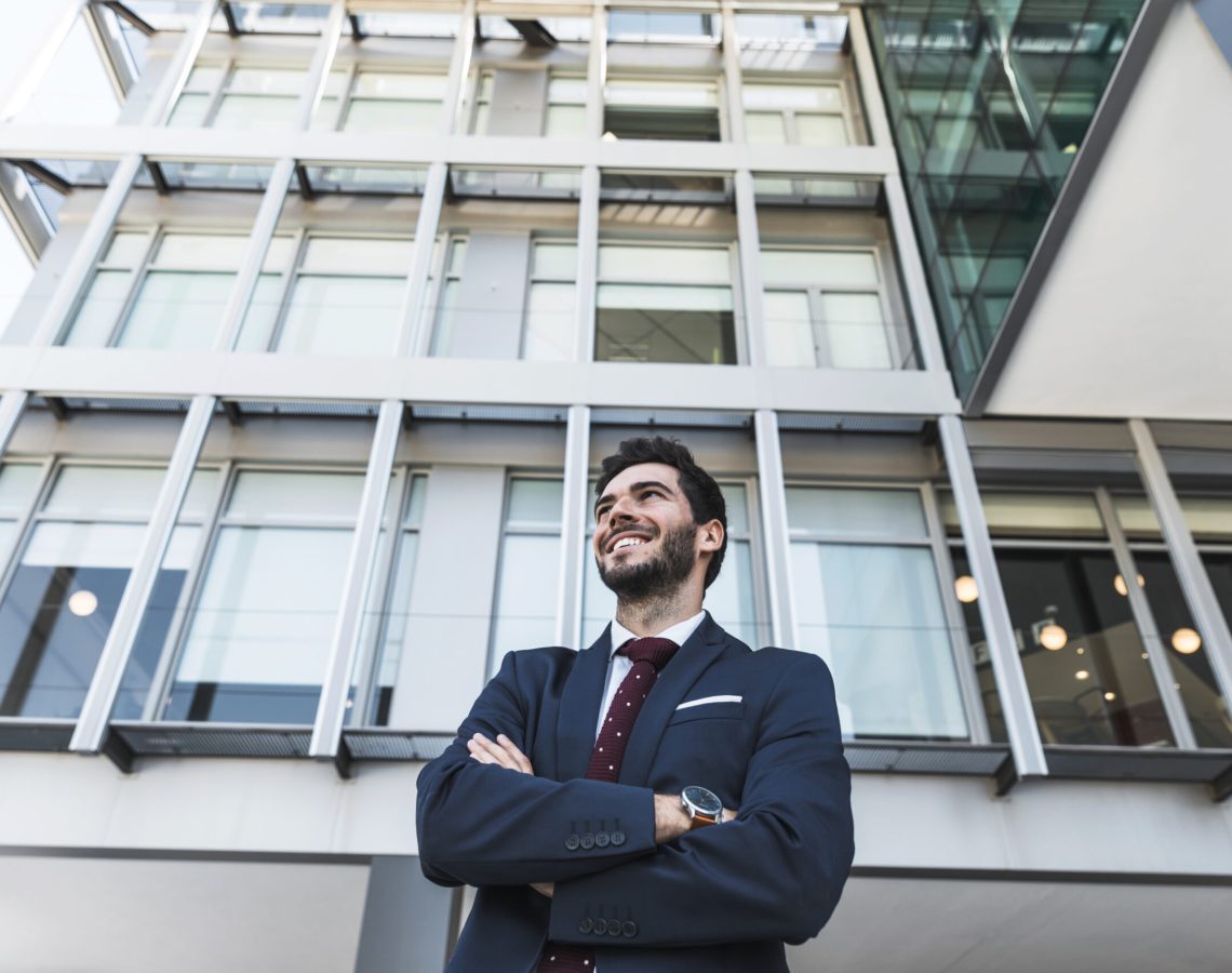 low-angle-smiley-lawyer-with-crossed-arms